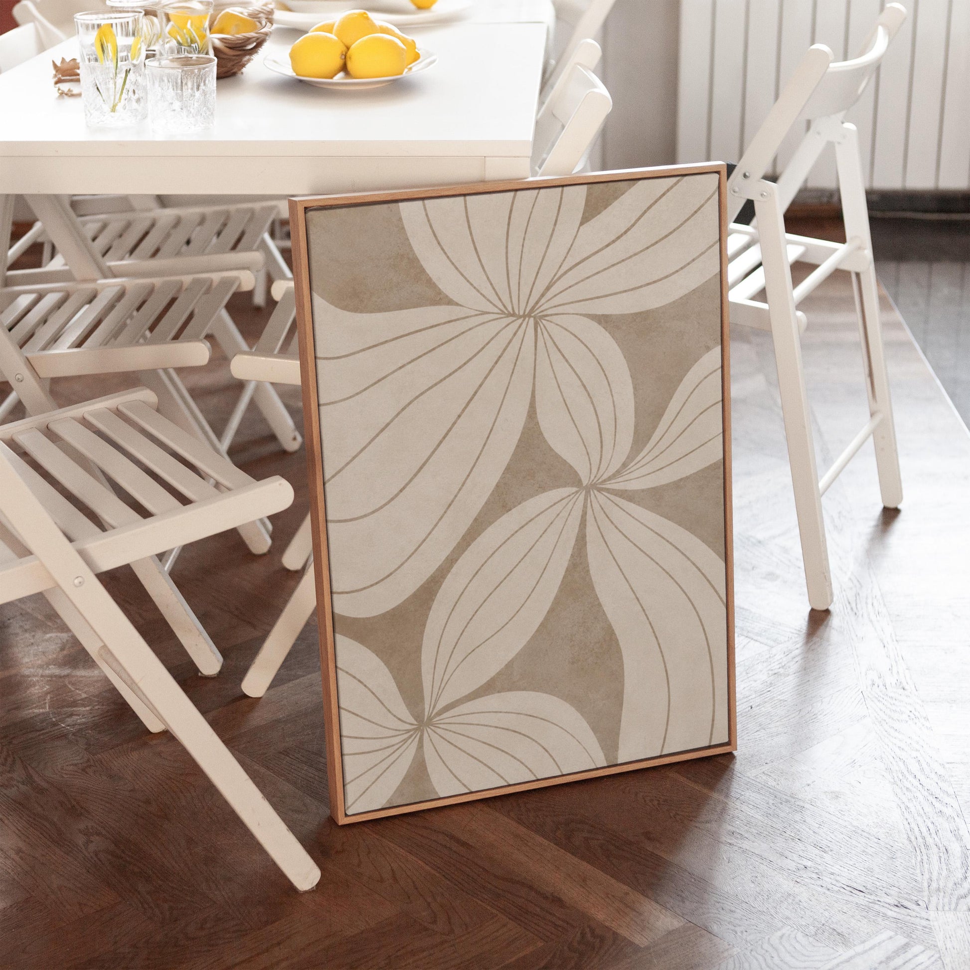 Abstract line drawing of oversized petals in cream and sand beige, canvas print hanging in a calm, modern living space