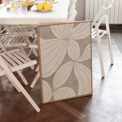 Abstract line drawing of oversized petals in cream and sand beige, canvas print hanging in a calm, modern living space