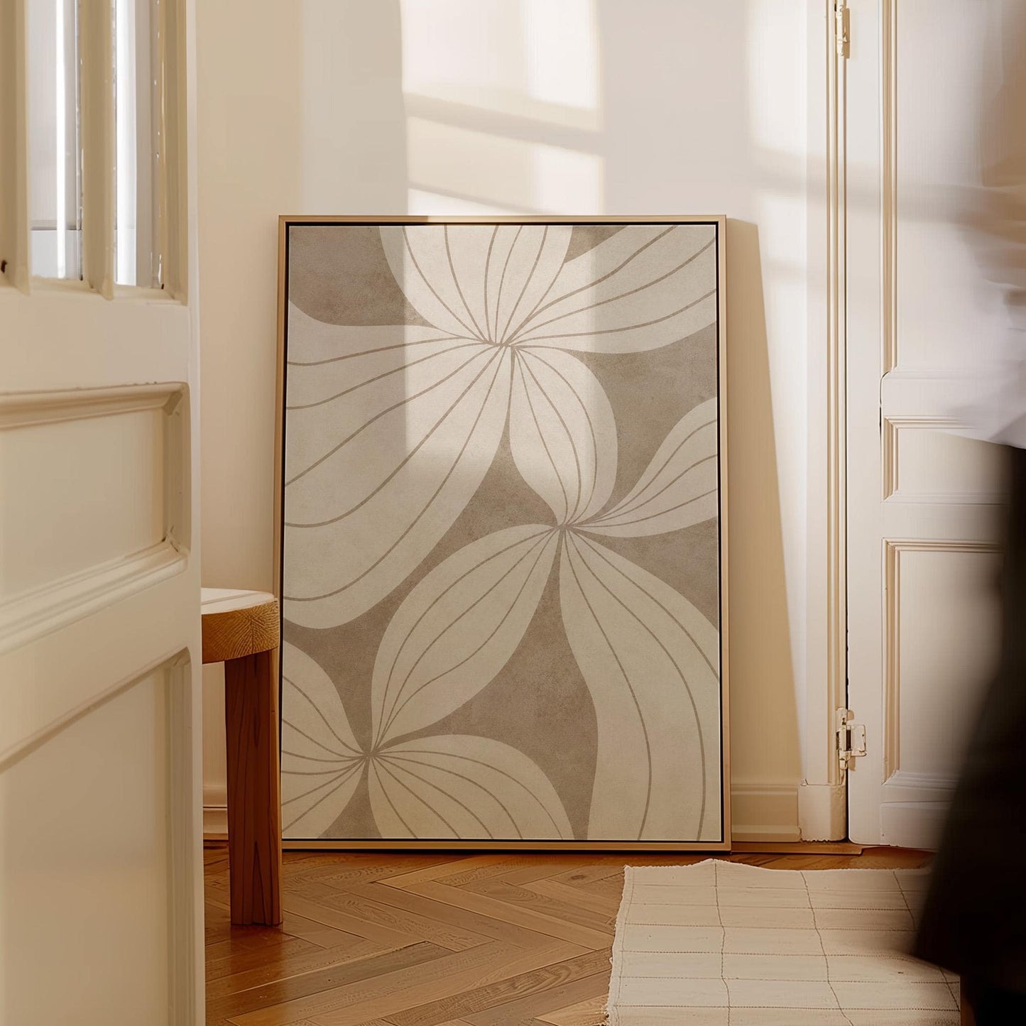 Abstract line drawing of oversized petals in cream and sand beige, canvas print presented in a light, minimal room