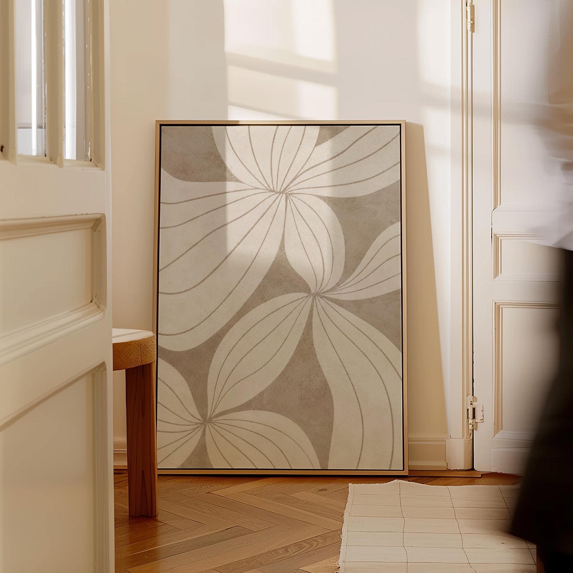 Abstract line drawing of oversized petals in cream and sand beige, canvas print presented in a light, minimal room