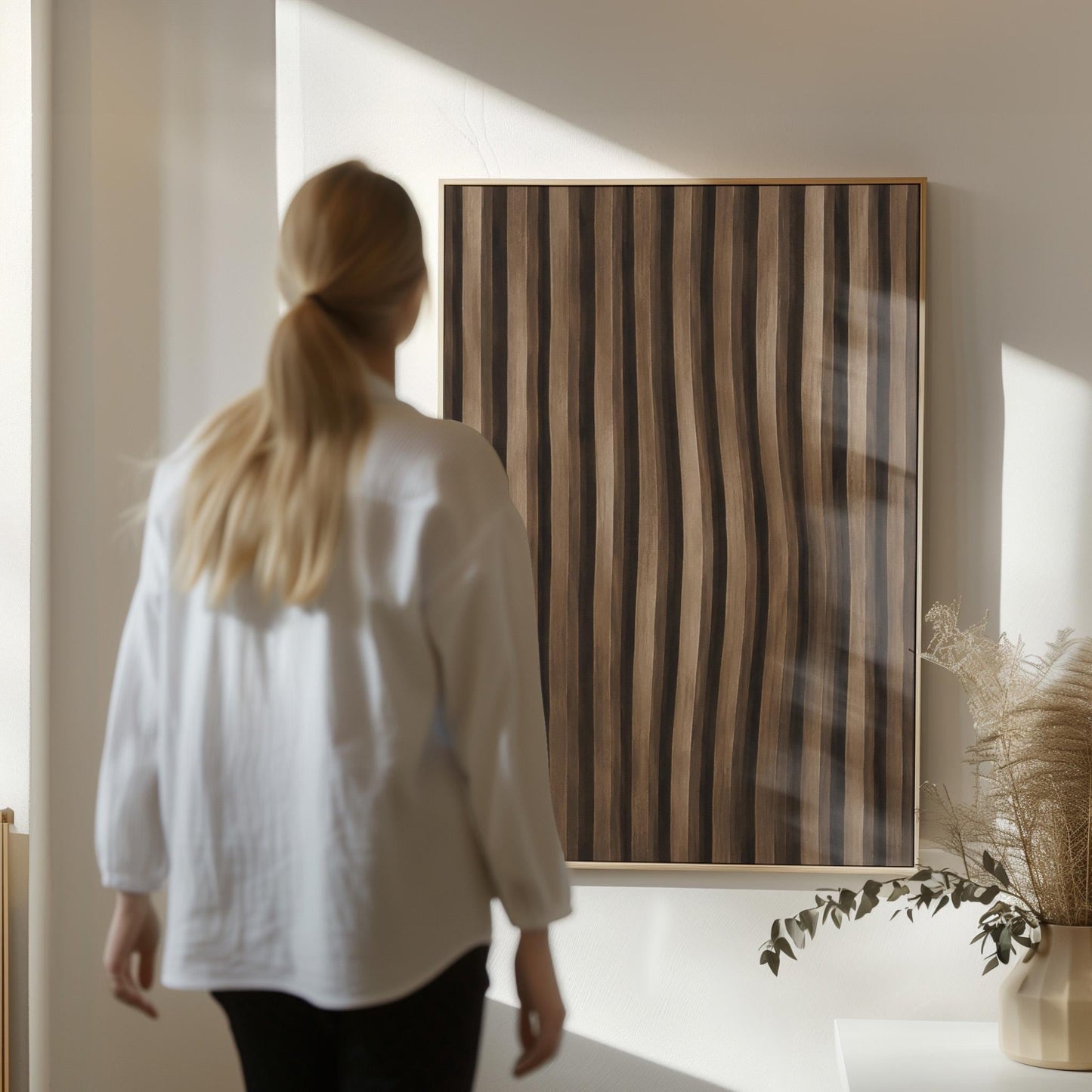 Vertical wavy stripes in dark walnut and coffee brown tones, canvas print hanging in a calm, modern living space