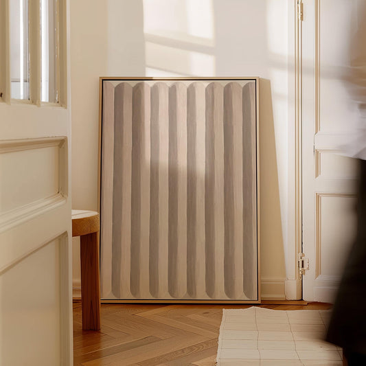 Vertical stripe pattern in blush pink and soft beige, canvas print hanging in a calm, modern living space