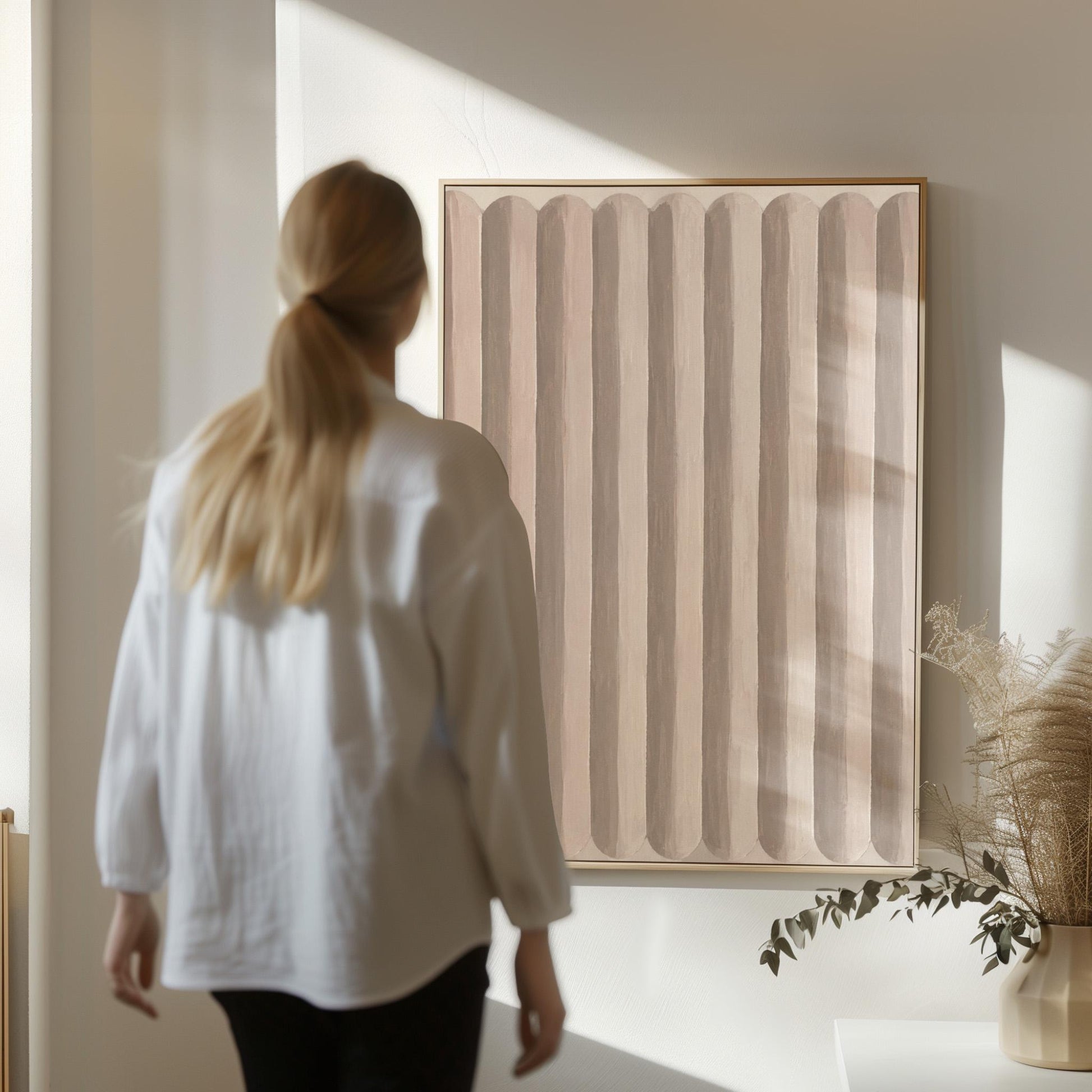 Vertical stripe pattern in blush pink and soft beige, canvas print styled against a soft white wall