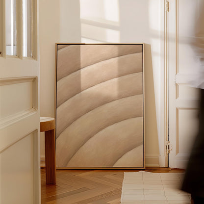 Broad sweeping arcs in cream and blush flowing across the frame, canvas print displayed on a neutral wall in a styled interior