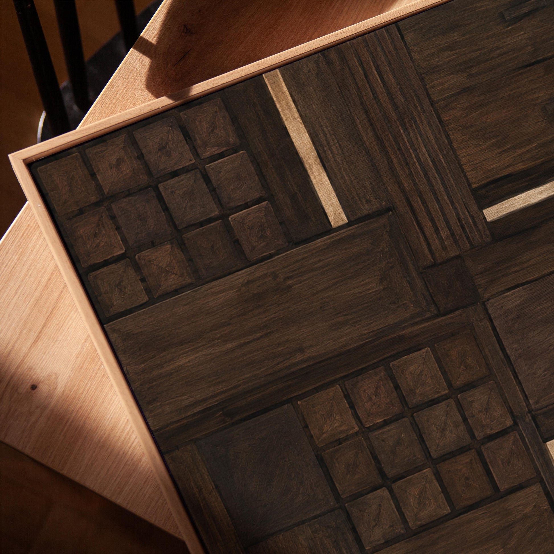 Dark espresso brown geometric patchwork with small gold accents, canvas print in a warm, minimally styled interior