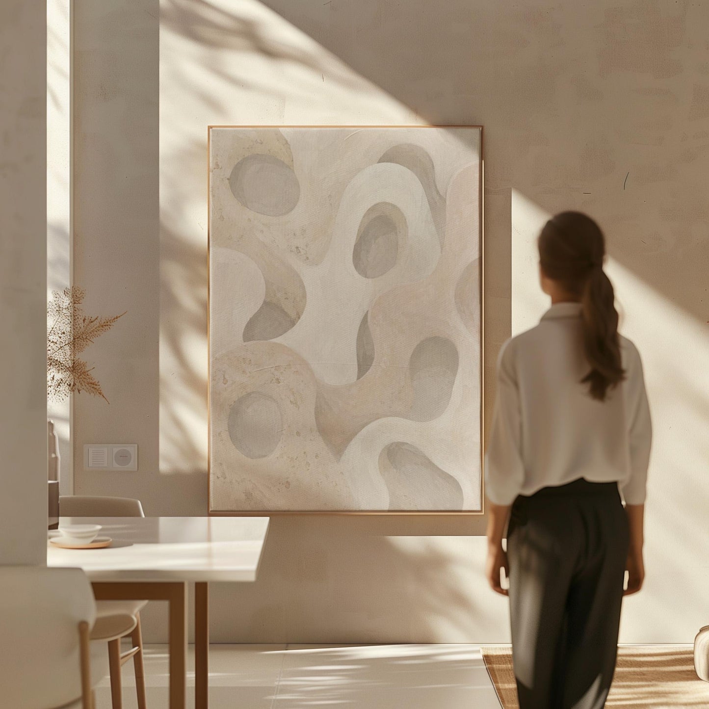 Soft organic flowing shapes in cream and light beige, canvas print seen in a warm interior with natural light