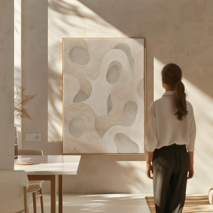 Soft organic flowing shapes in cream and light beige, canvas print seen in a warm interior with natural light