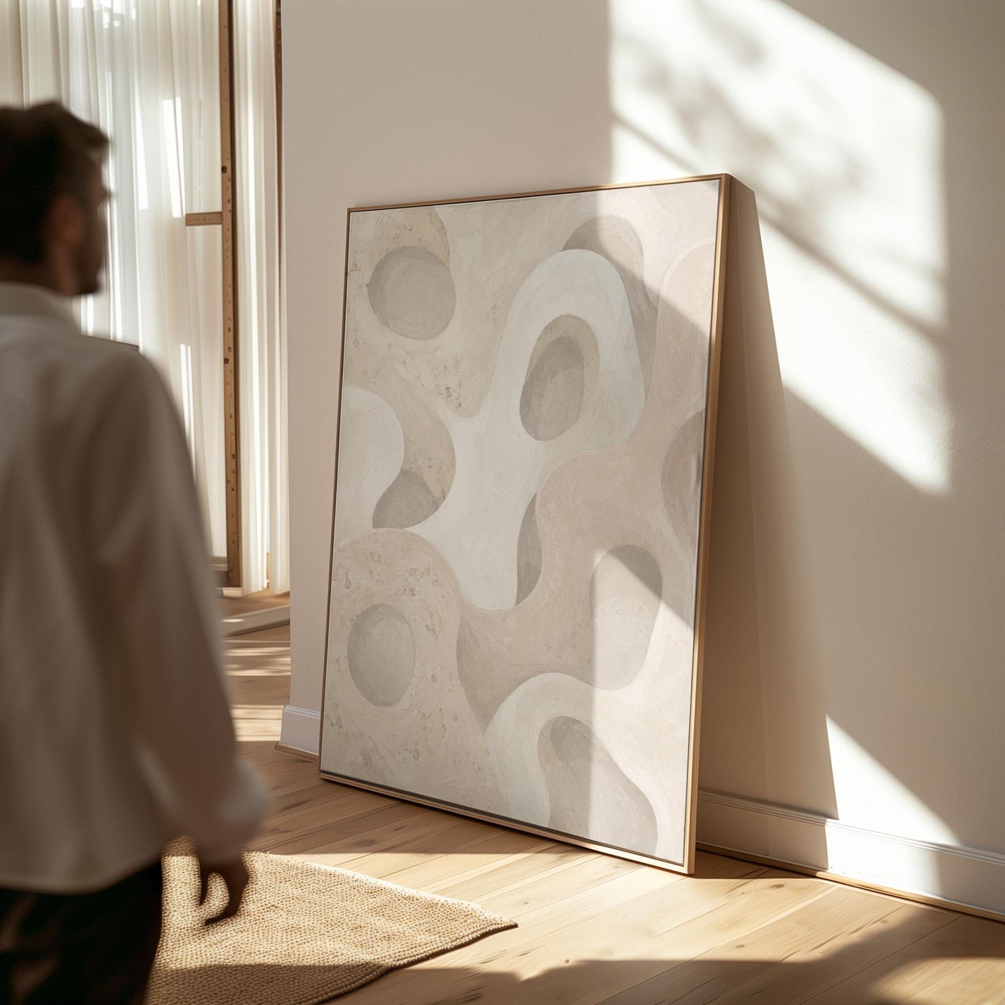 Soft organic flowing shapes in cream and light beige, canvas print displayed on a neutral wall in a styled interior