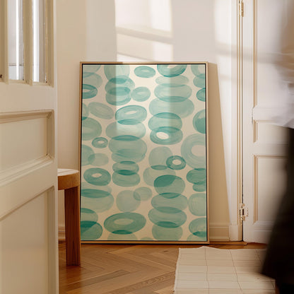 Watercolor rings and ovals in aqua and teal like sea glass, canvas wall art hanging in a calm, modern living space