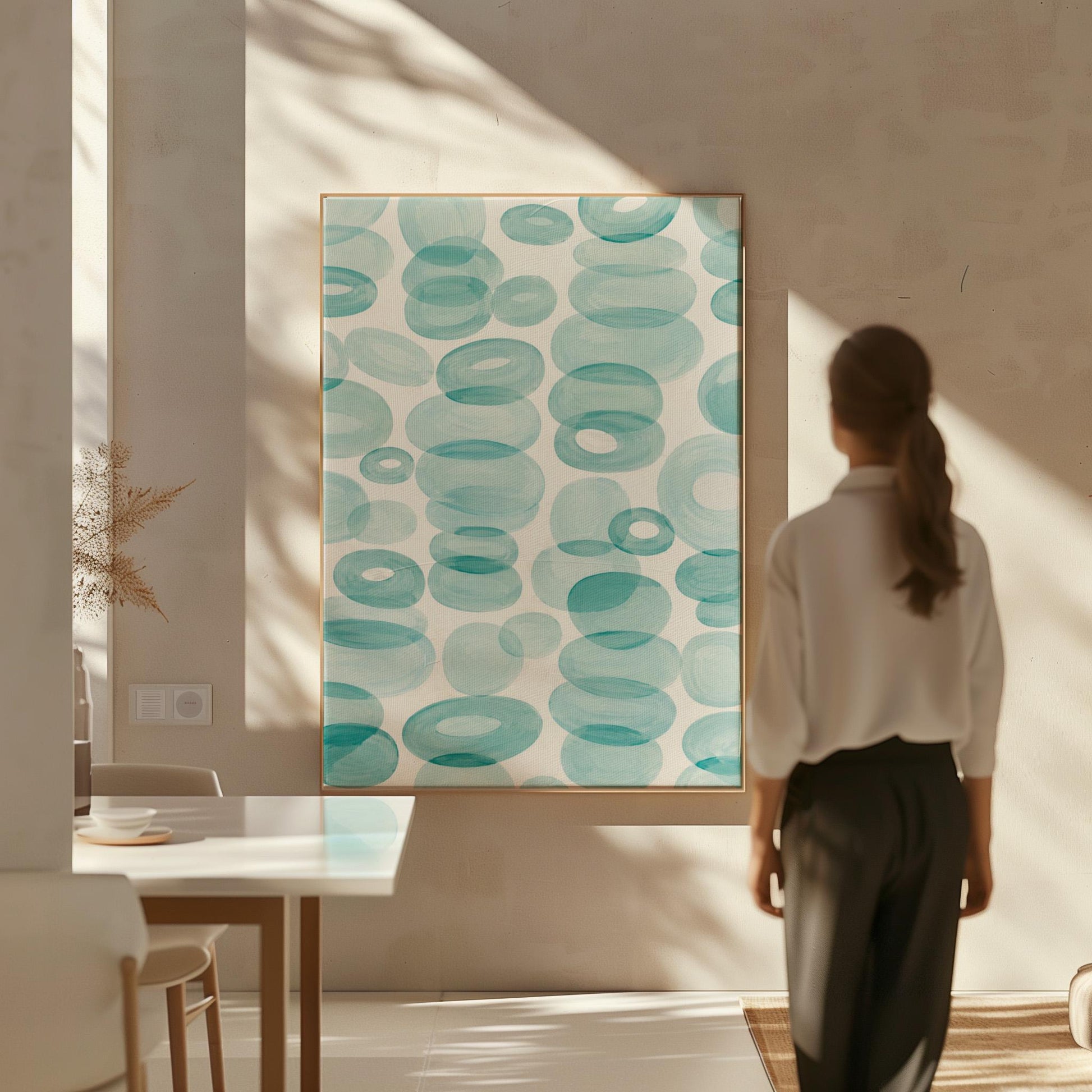 Watercolor rings and ovals in aqua and teal like sea glass, canvas wall art on a quiet wall in a considered interior