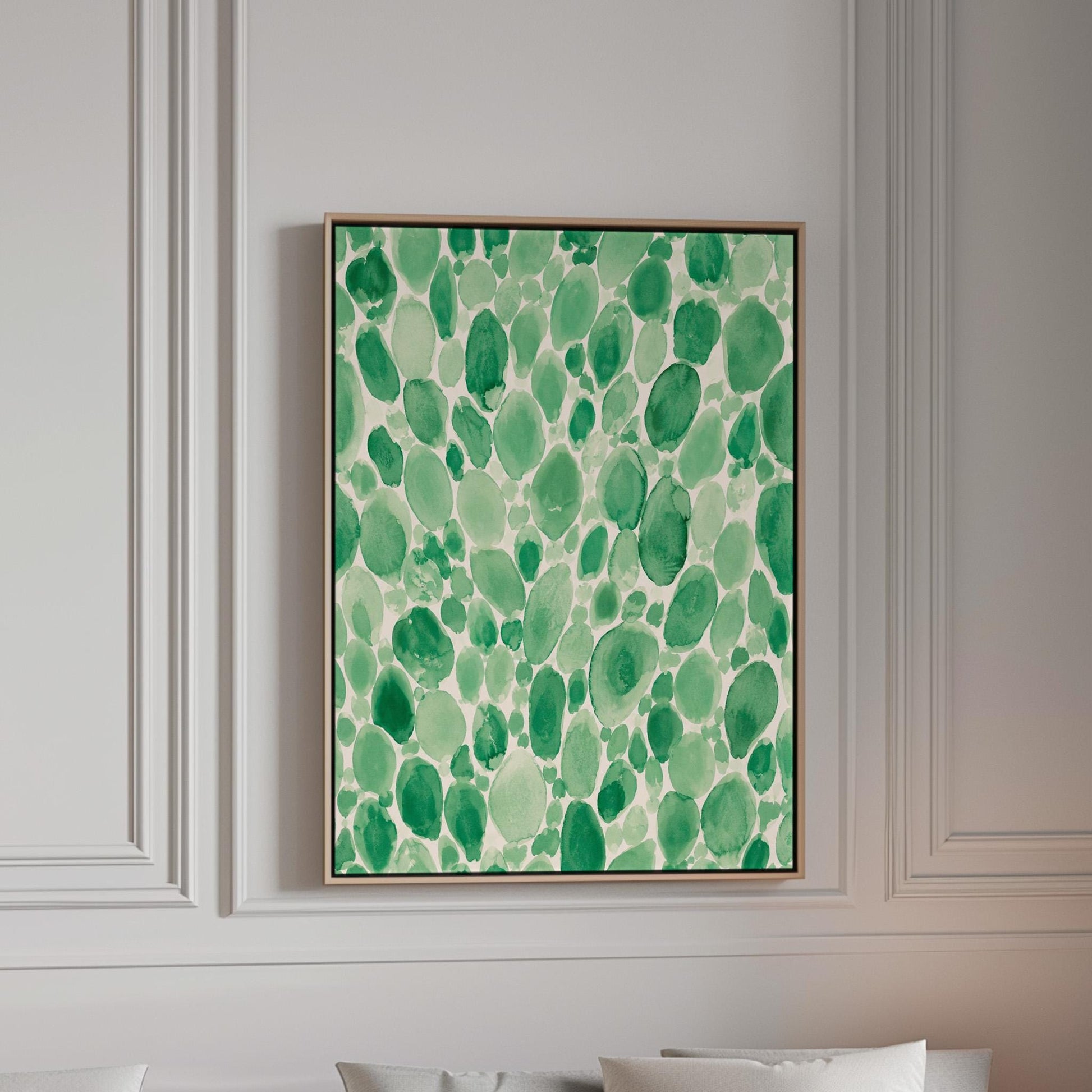 Dense watercolor pebble shapes in mint to emerald green, canvas print in a bright room with natural daylight