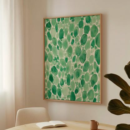 Dense watercolor pebble shapes in mint to emerald green, canvas print hanging in a calm, modern living space