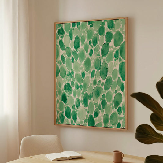 Dense watercolor pebble shapes in mint to emerald green, canvas print hanging in a calm, modern living space