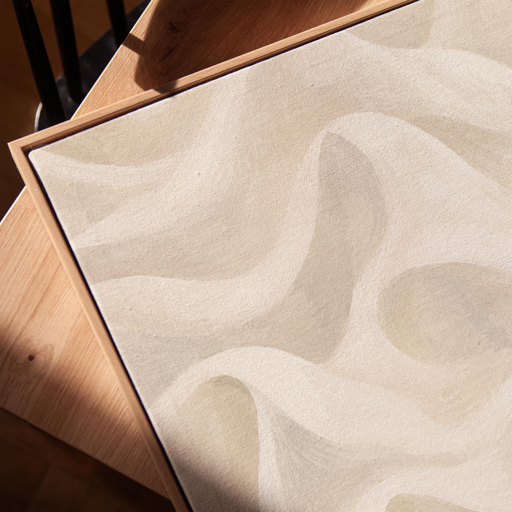 Flowing silky wave shapes in ivory and warm white, canvas print in a warm, minimally styled interior