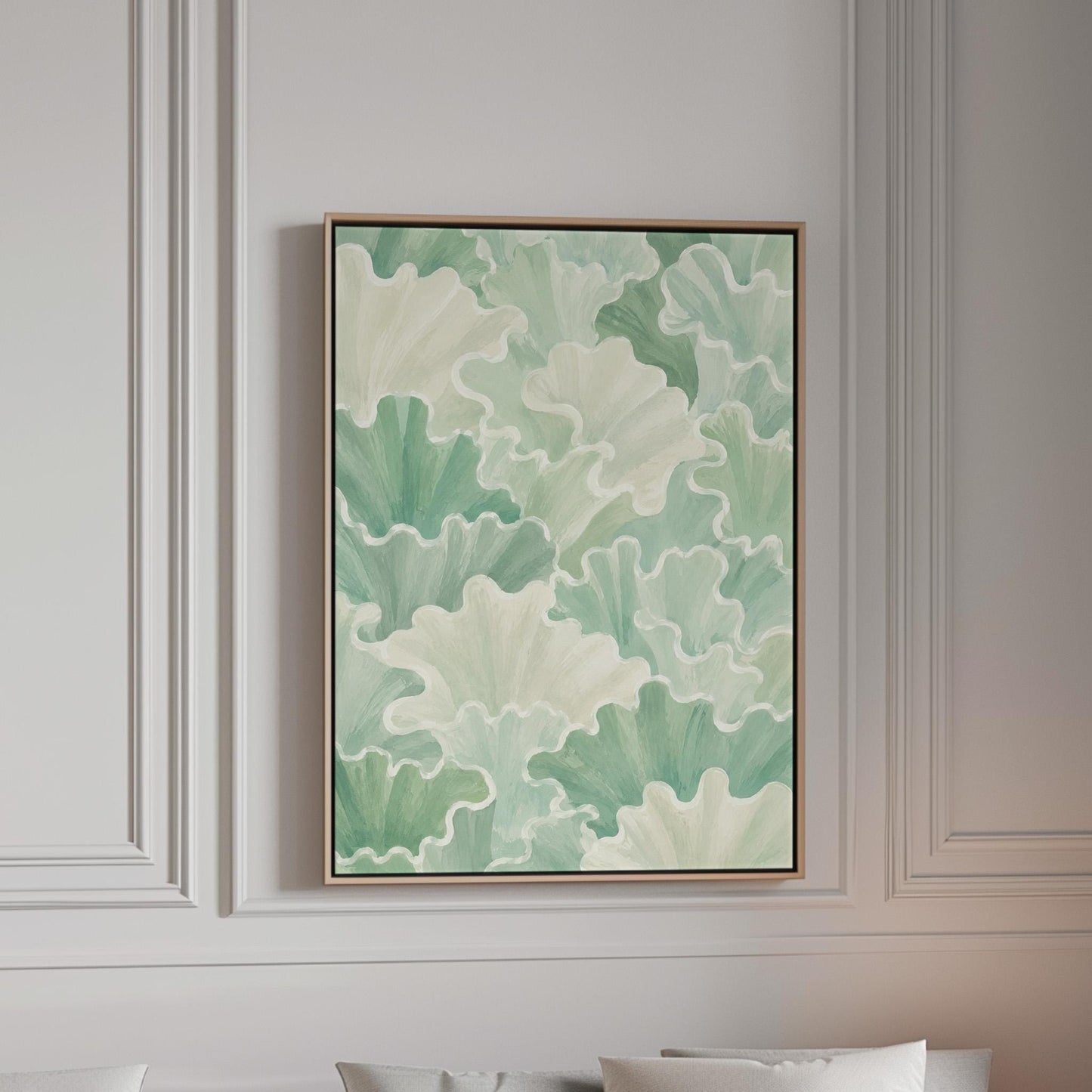 Fan shaped leafy forms in soft sage green watercolor, canvas print in a bright room with natural daylight
