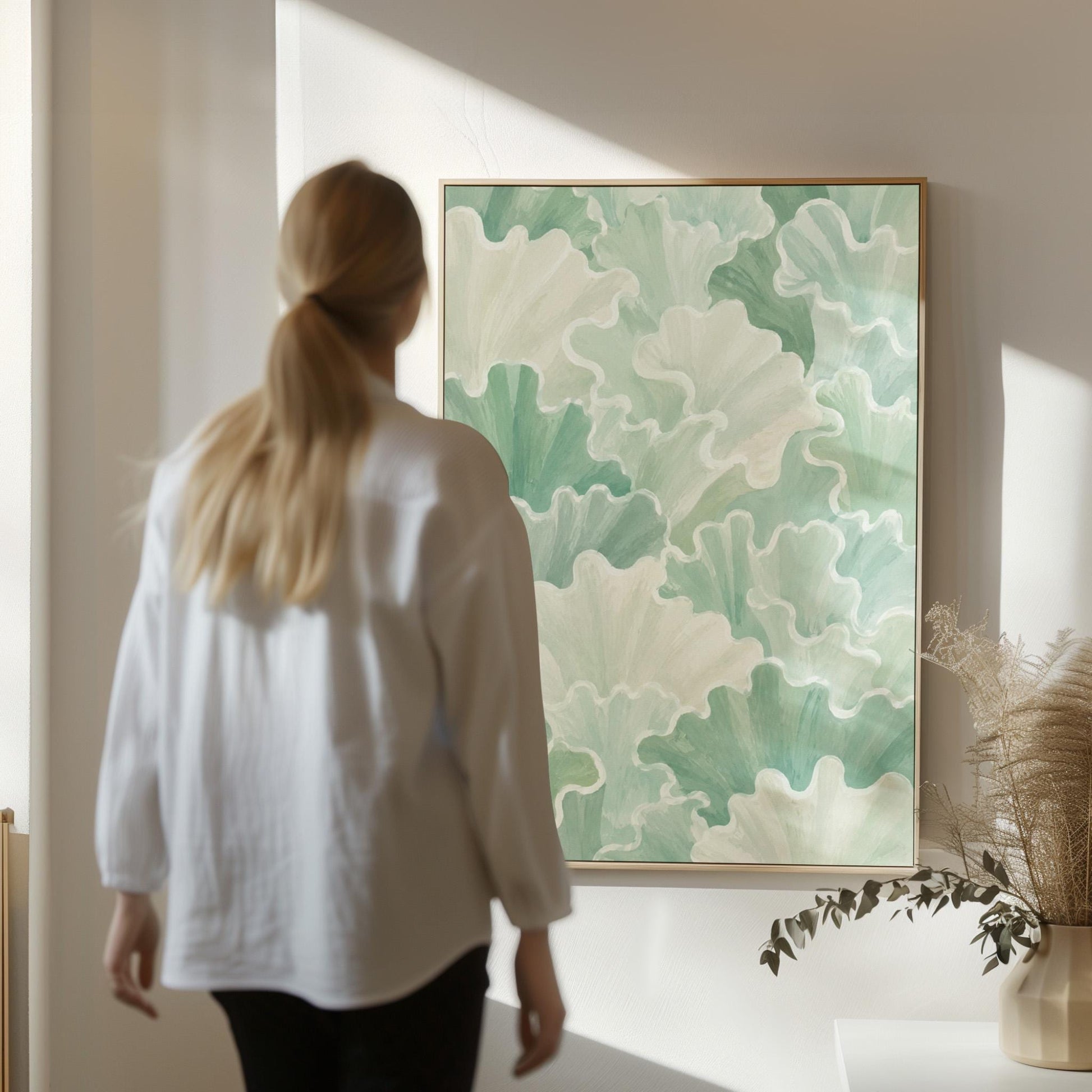 Fan shaped leafy forms in soft sage green watercolor, canvas print shown in a sunlit, contemporary room