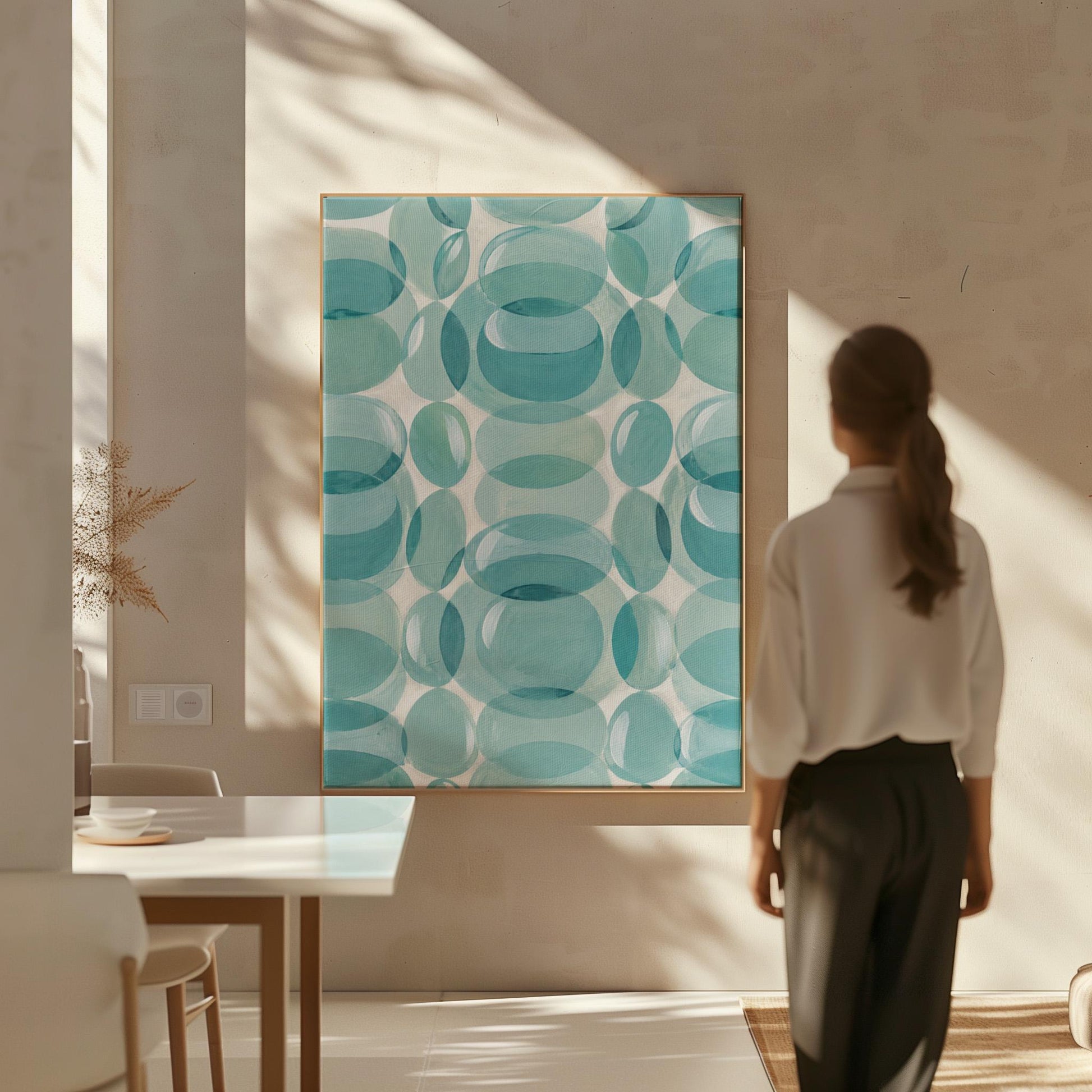 Overlapping translucent circles in teal and aqua tones, canvas print shown in a sunlit, contemporary room