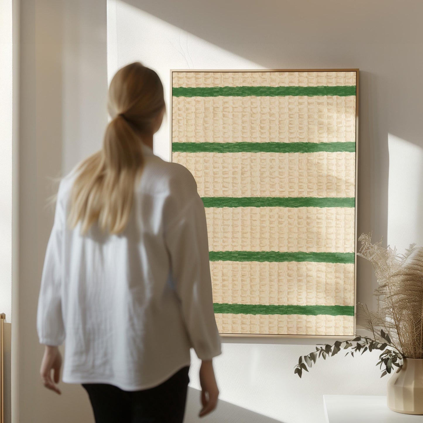 Horizontal grass green stripes on a cream background, canvas print on a quiet wall in a considered interior