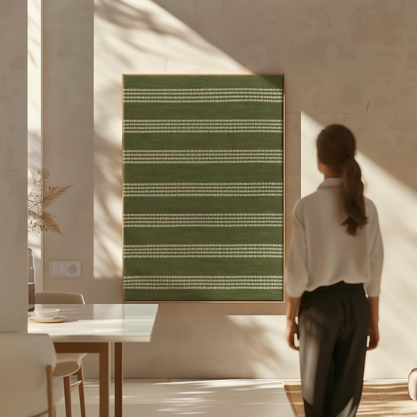 Olive green field with thin cream pinstripe rows, canvas print hanging in a calm, modern living space