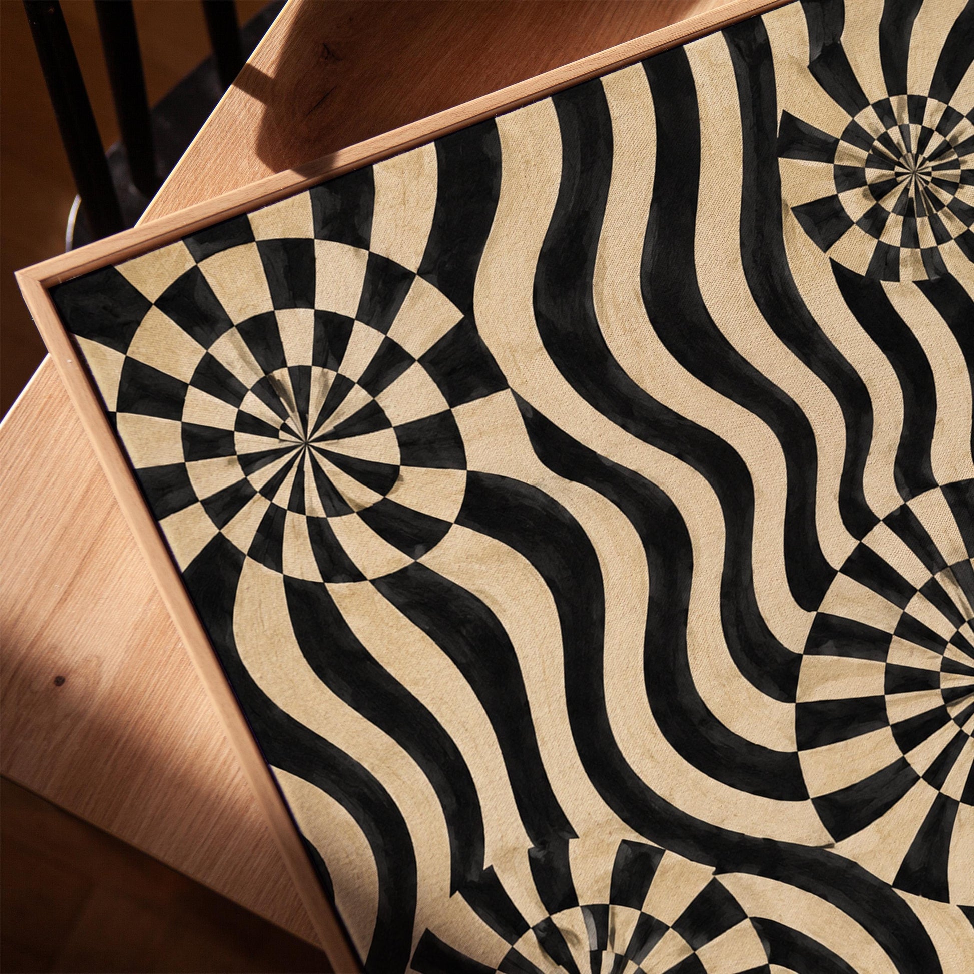 Swirling wavy stripes with spiral discs in black and ivory, canvas print in a warm, minimally styled interior