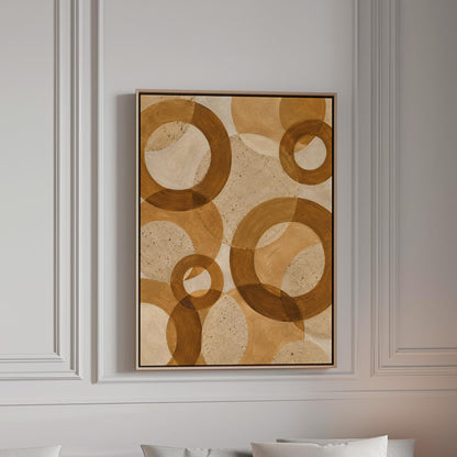Overlapping translucent circles in amber and terracotta, canvas print in a bright room with natural daylight