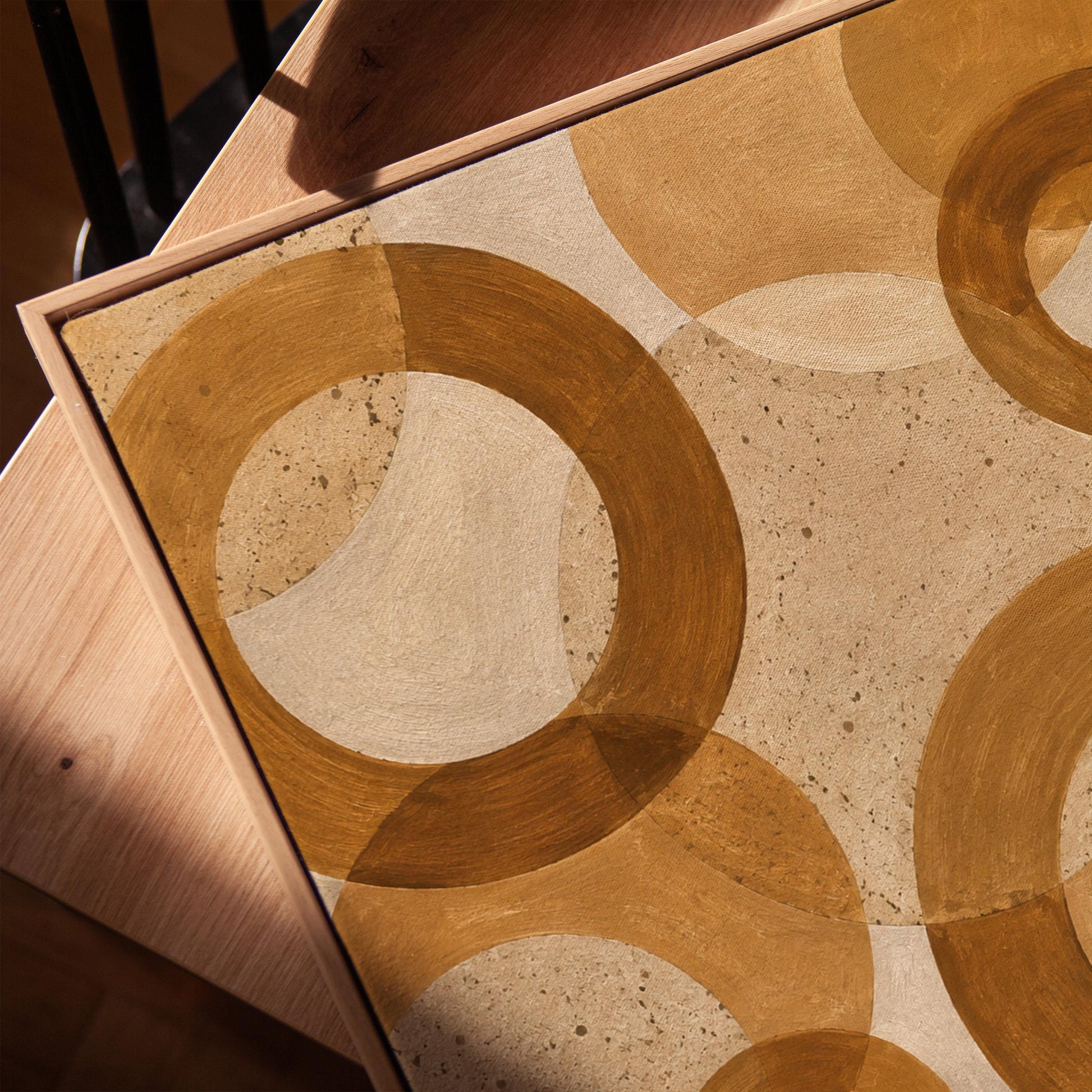 Overlapping translucent circles in amber and terracotta, canvas print in a warm, minimally styled interior