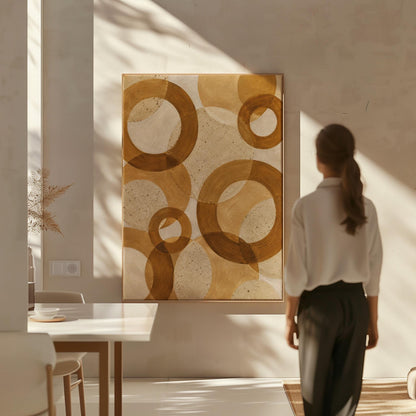 Overlapping translucent circles in amber and terracotta, canvas print seen in a warm interior with natural light