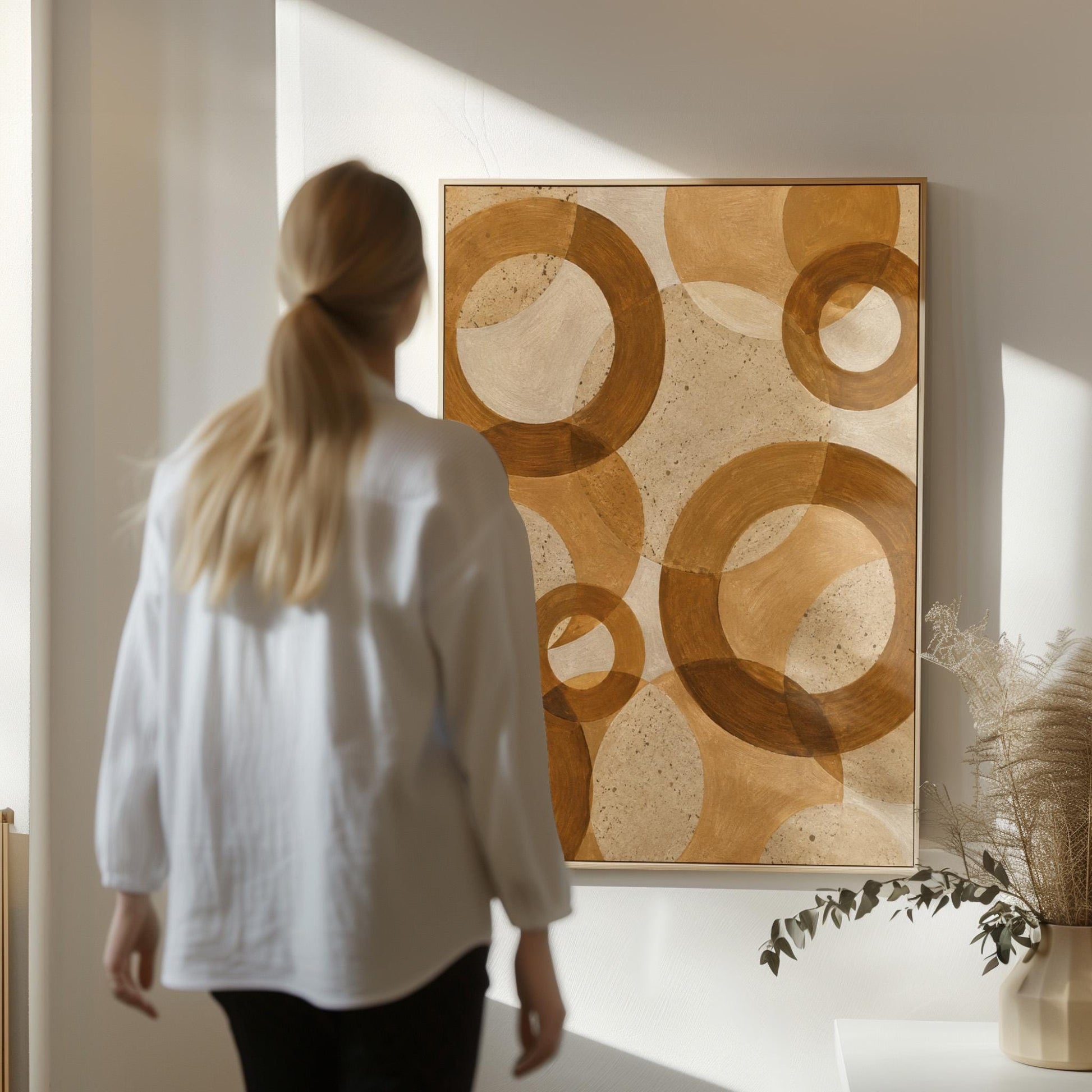 Overlapping translucent circles in amber and terracotta, canvas print presented in a light, minimal room