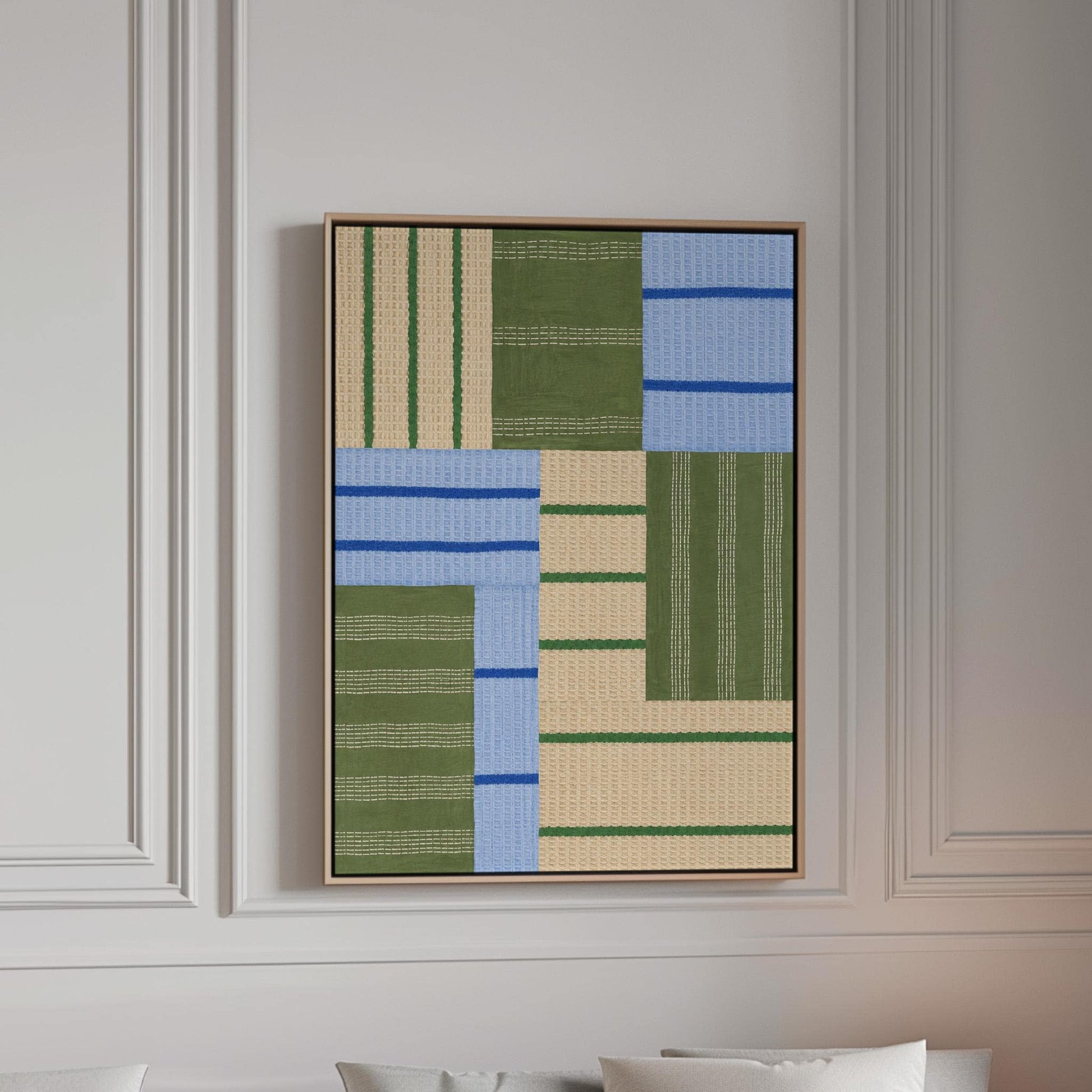 Patchwork of sage green fields with periwinkle blue bands, canvas print in a bright room with natural daylight