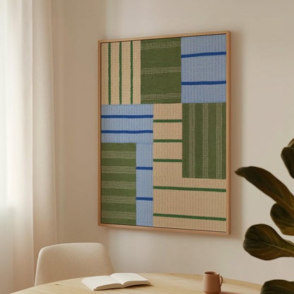 Patchwork of sage green fields with periwinkle blue bands, canvas print hanging in a calm, modern living space