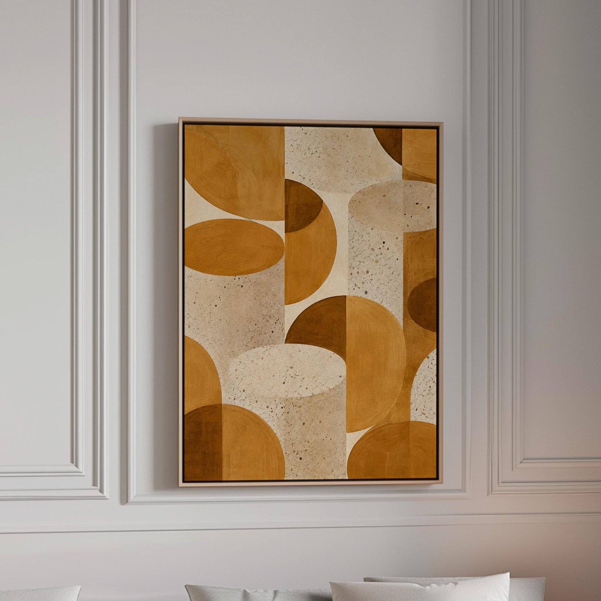 Warm caramel geometric shapes on speckled cream background, canvas print in a bright room with natural daylight
