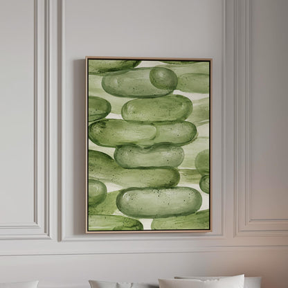 Stacked smooth green stones painted in watercolor, canvas print in a bright room with natural daylight