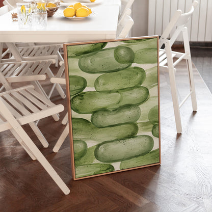 Stacked smooth green stones painted in watercolor, canvas print displayed on a neutral wall in a styled interior