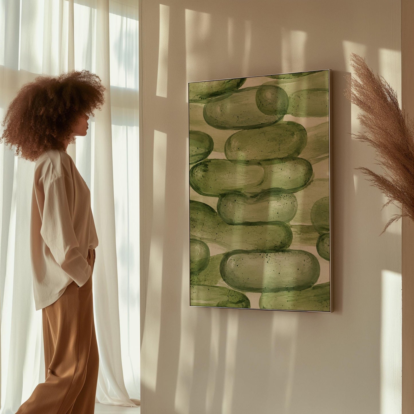 Stacked smooth green stones painted in watercolor, canvas wall art styled against a soft white wall