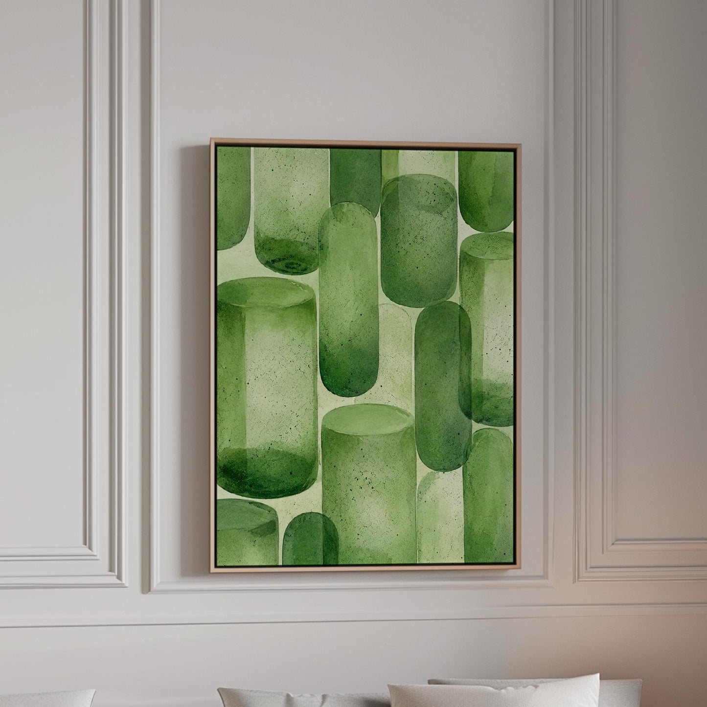 Rounded capsule shapes in layered watercolor greens, canvas print in a bright room with natural daylight