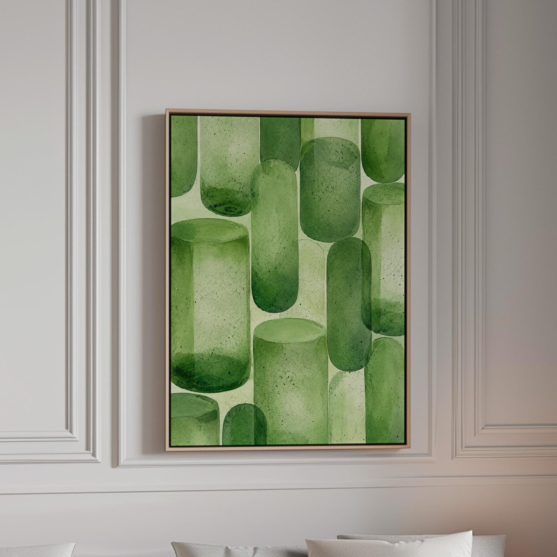 Rounded capsule shapes in layered watercolor greens, canvas print in a bright room with natural daylight