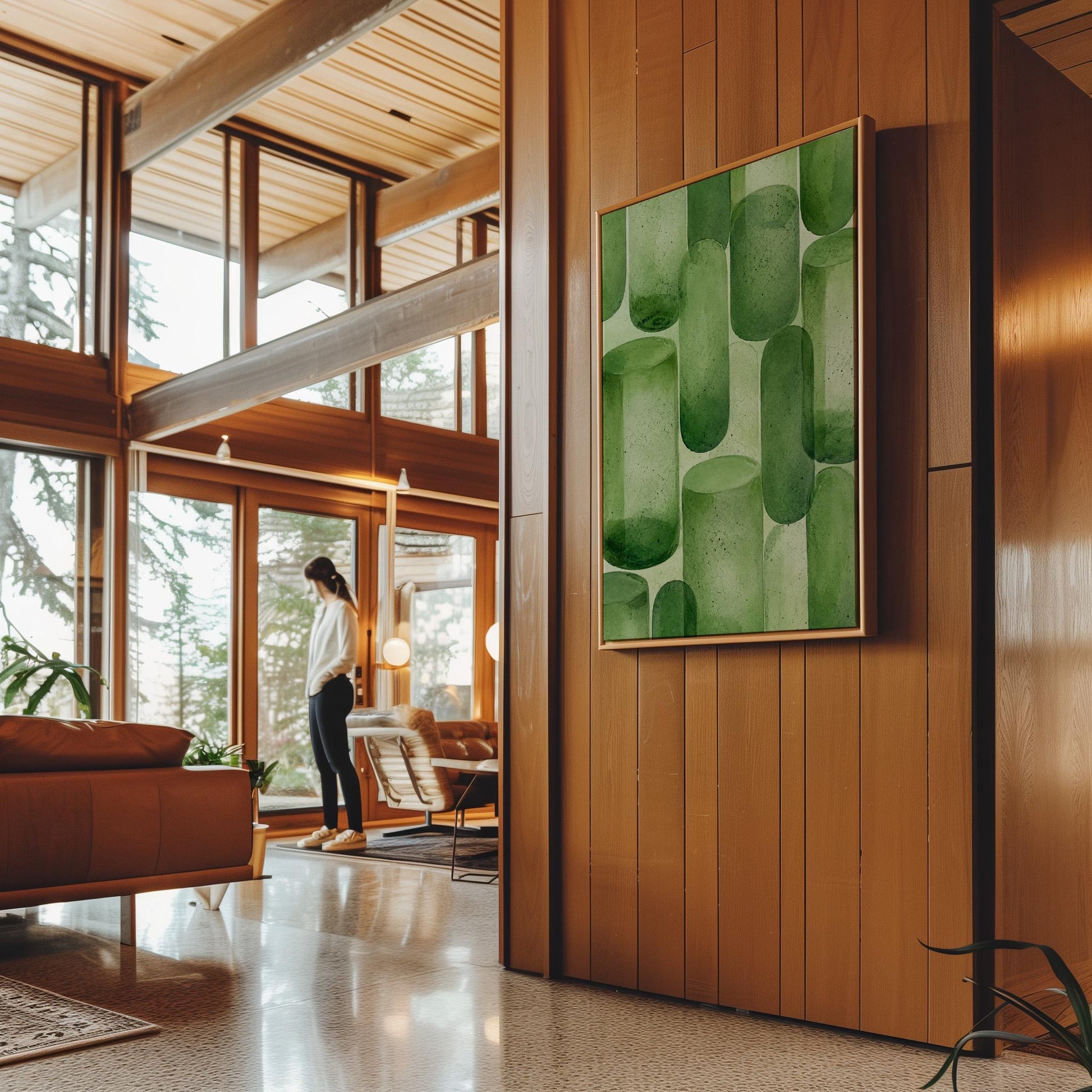 Rounded capsule shapes in layered watercolor greens, canvas print seen in a warm interior with natural light