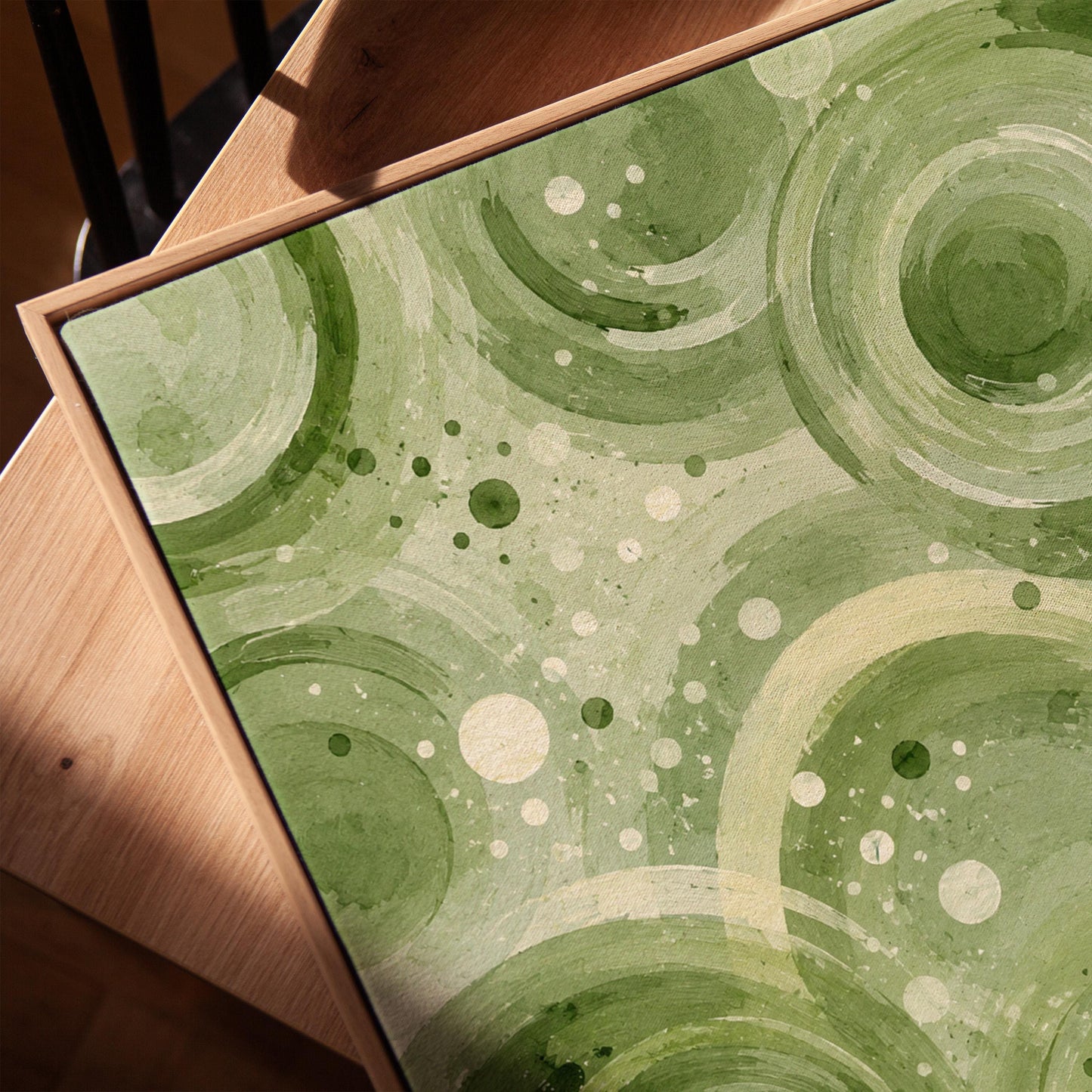 Rings and bubbles swirling in sage green watercolor, canvas print in a warm, minimally styled interior