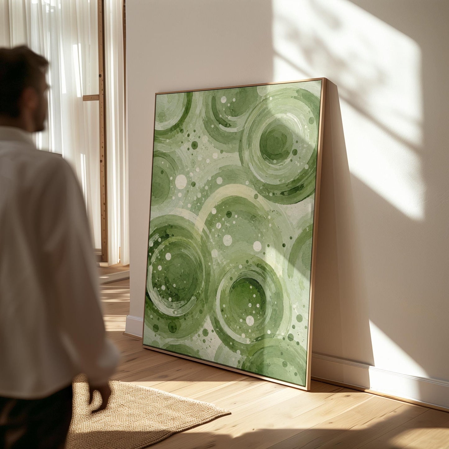 Rings and bubbles swirling in sage green watercolor, canvas print hanging in a calm, modern living space