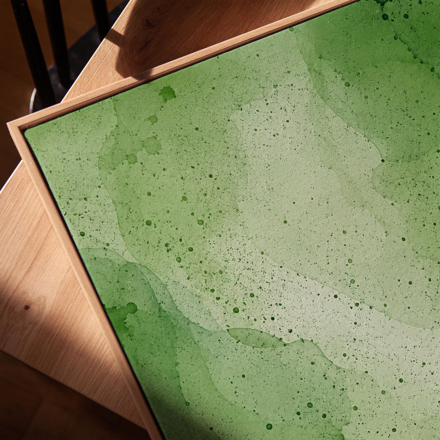 Loose watercolor wash in deep moss and forest greens, canvas print in a warm, minimally styled interior