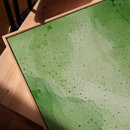 Loose watercolor wash in deep moss and forest greens, canvas print in a warm, minimally styled interior