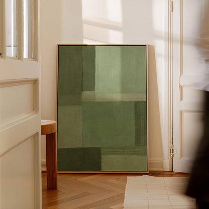 Tonal color blocks in muted sage and olive green, canvas wall art hanging in a calm, modern living space