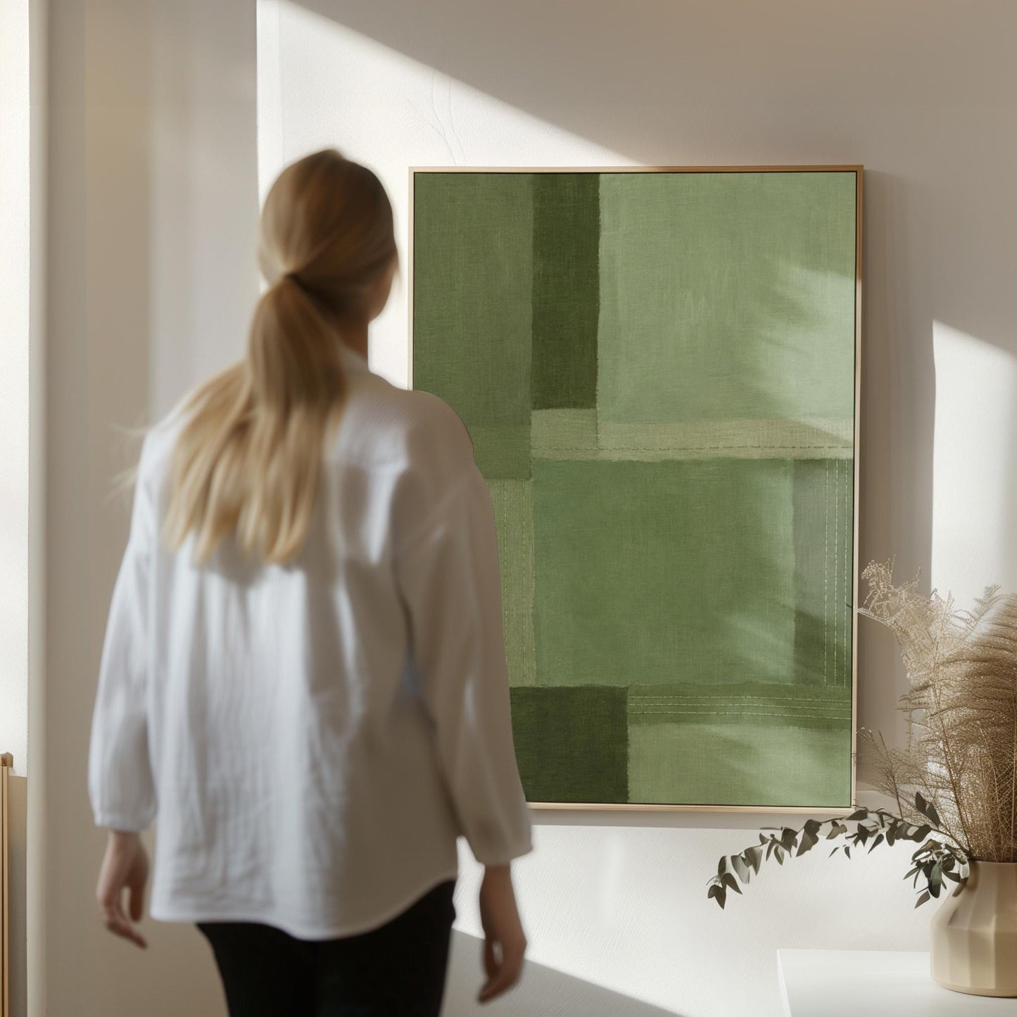 Tonal color blocks in muted sage and olive green, canvas wall art on a quiet wall in a considered interior