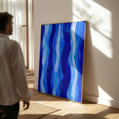 Vertical flowing ribbons in cobalt and light blue, canvas print hanging in a calm, modern living space
