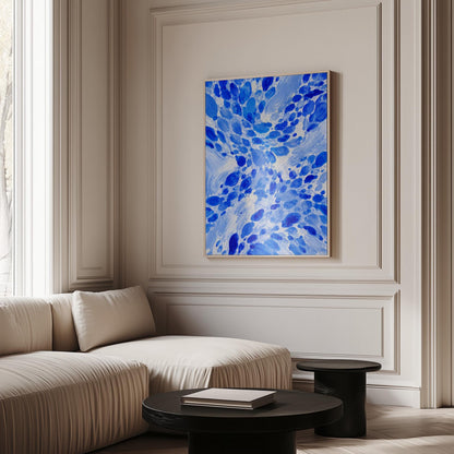 Burst of cobalt blue droplets scattering across pale background, canvas print styled against a soft white wall