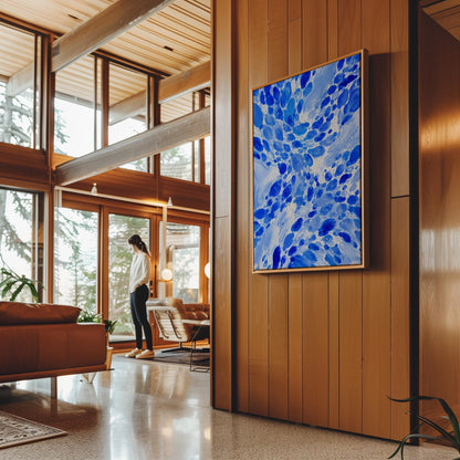 Burst of cobalt blue droplets scattering across pale background, canvas wall art styled against a soft white wall