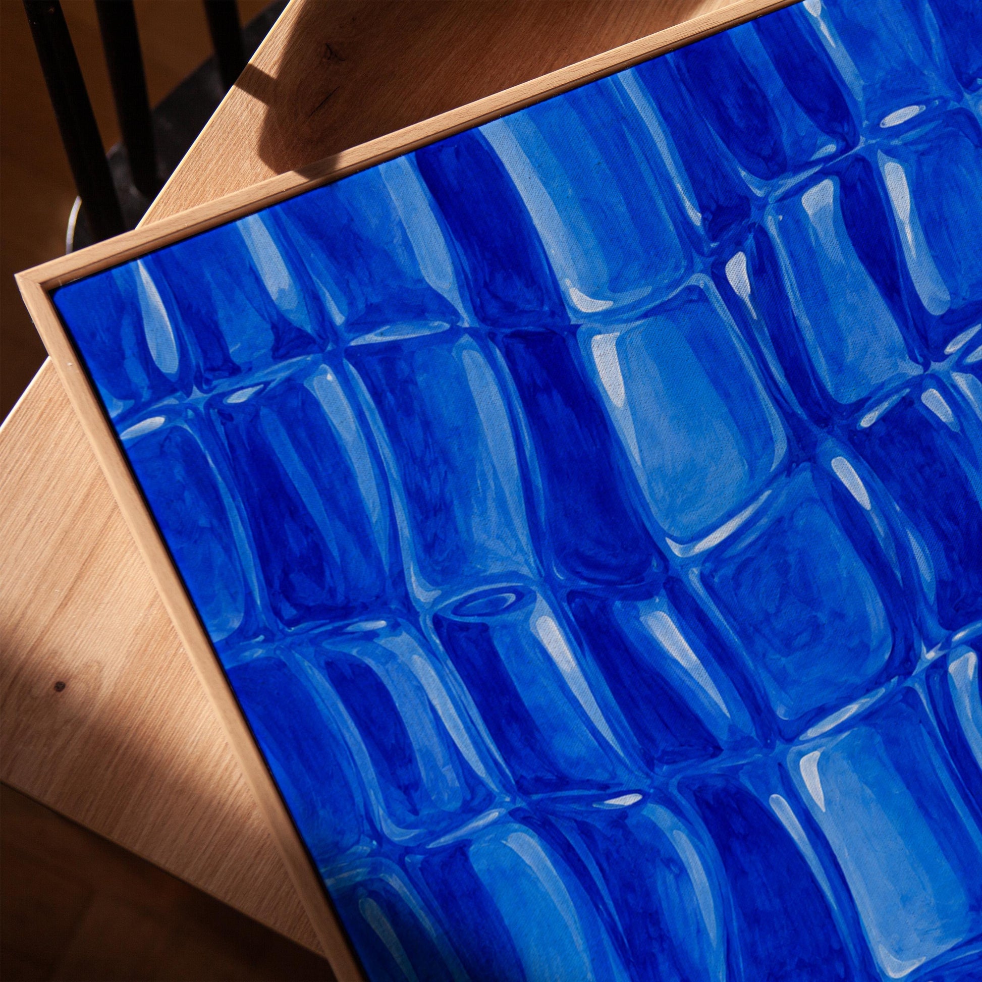 Mosaic of rounded royal blue shapes like cobblestones, canvas print in a warm, minimally styled interior