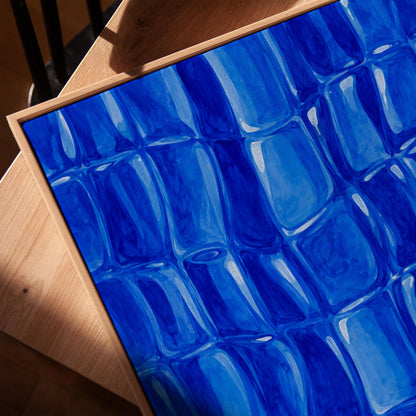 Mosaic of rounded royal blue shapes like cobblestones, canvas print in a warm, minimally styled interior