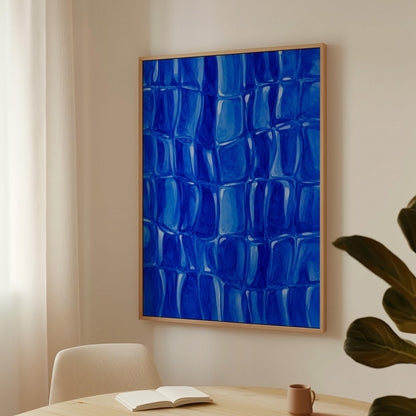 Mosaic of rounded royal blue shapes like cobblestones, canvas wall art seen in a warm interior with natural light
