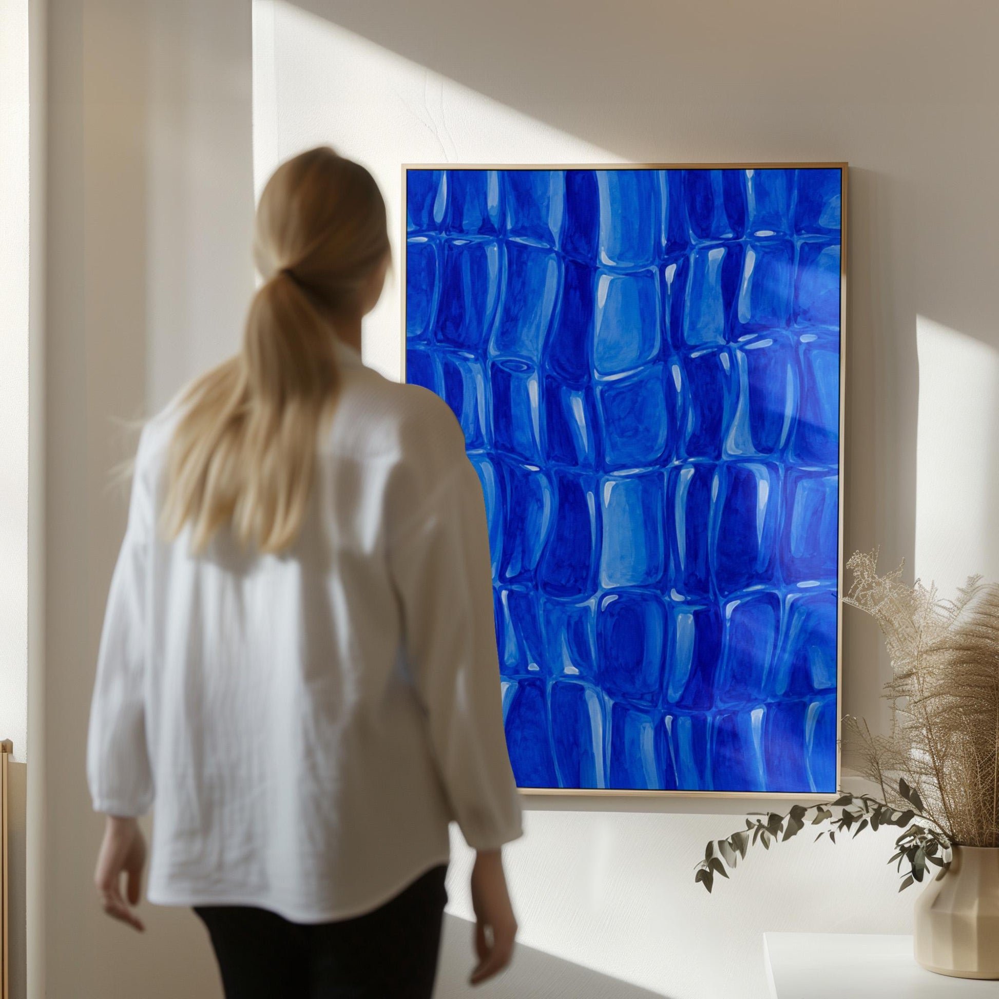 Mosaic of rounded royal blue shapes like cobblestones, canvas wall art presented in a light, minimal room